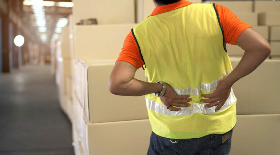 Commentary 11 Asian man worker in a warehouse have an accident while carrying a heavy cardboard boxes with careless, male worker have a critical accident and injured at his back.